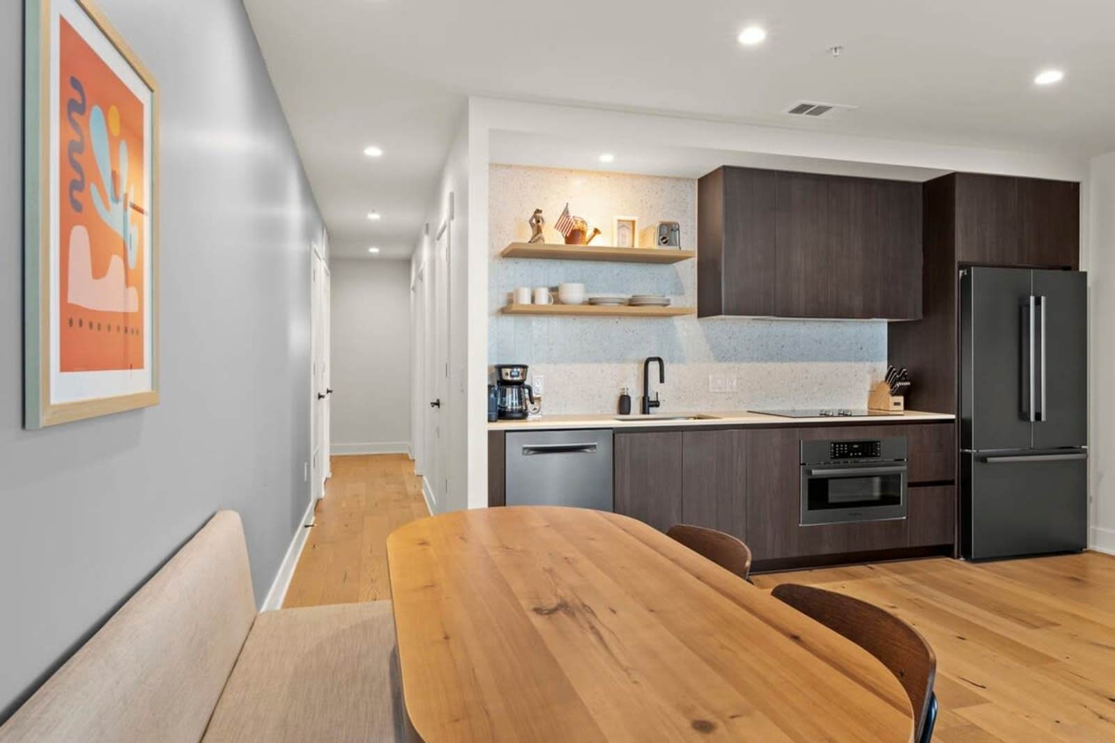 Entry hall of unit 1804 looking past the dining table into the kitchen