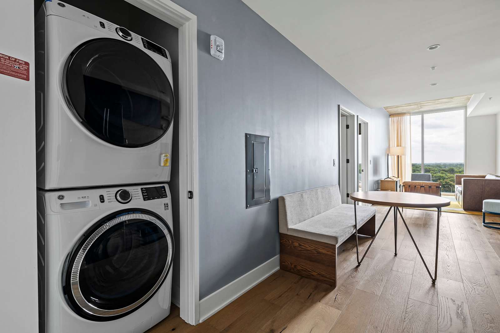 Stacked washer and dryer inside unit 1204, in a closet off the main living space