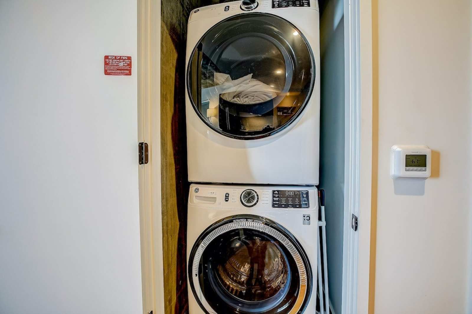 Stacked washer and dryer inside unit 1406