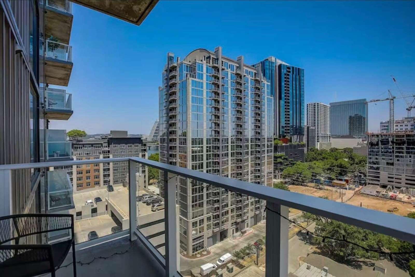 Balcony of unit 1504 looking across downtown Austin towers under a clear sky